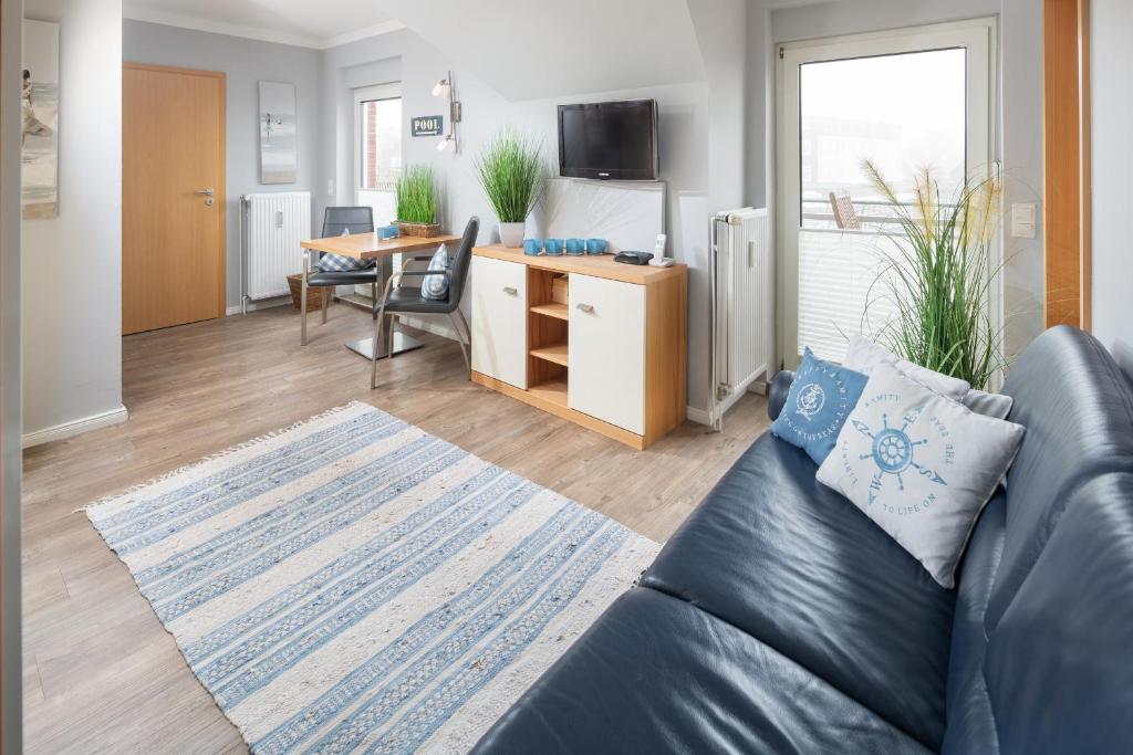 a living room with a couch and a table at Schönster Blick in Juist