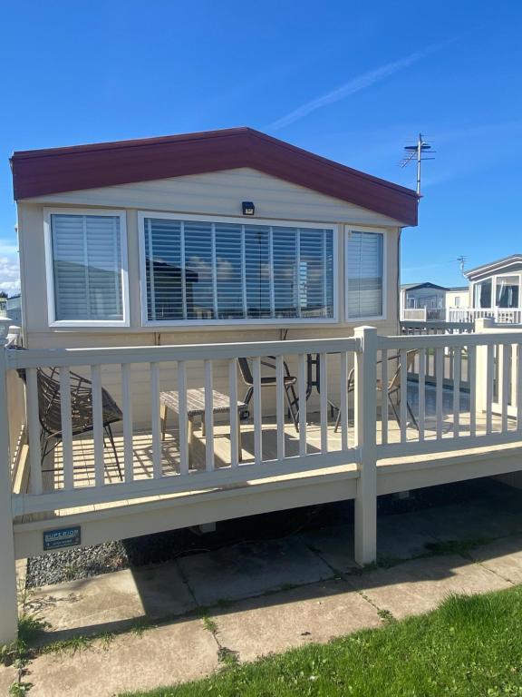 a home with a white deck and railing at Lisa caravan hire in Skegness