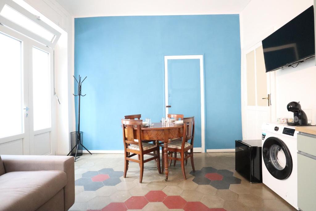 a living room with a table and a blue wall at Lessolo29 in Turin