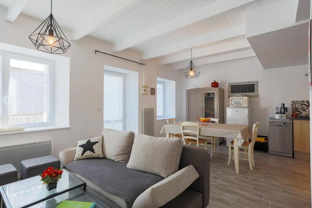 a living room with a couch and a table at Charmante maison à Pleubian in Pleubian