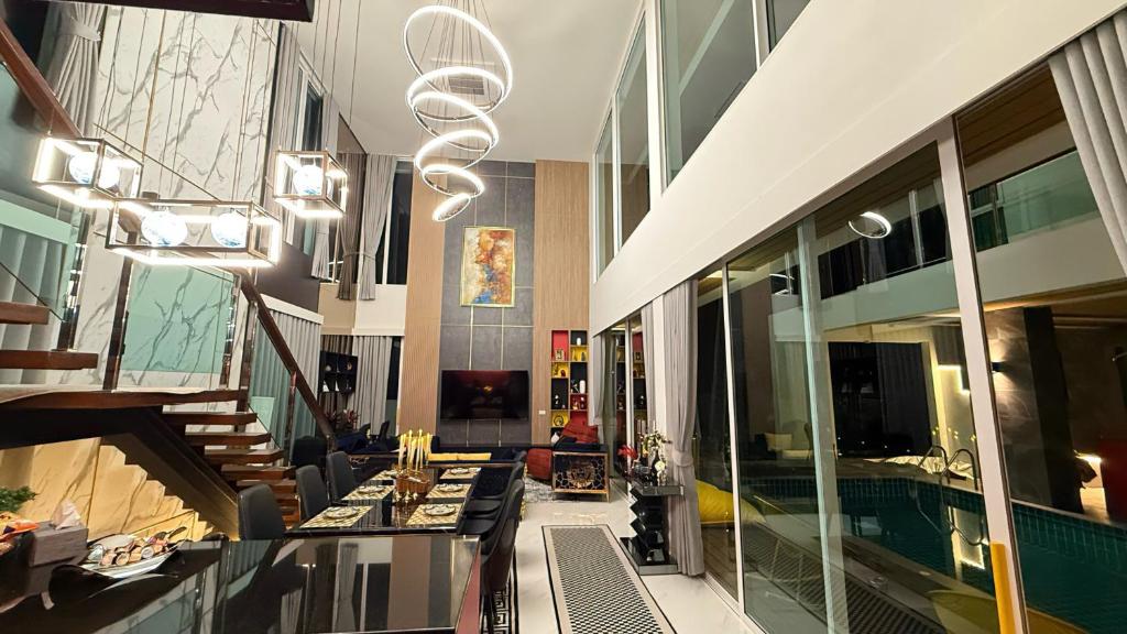a living room with a pool in a building at De Flourishing Hill Pool Villa , Cha Am in Ban Nong Chaeng