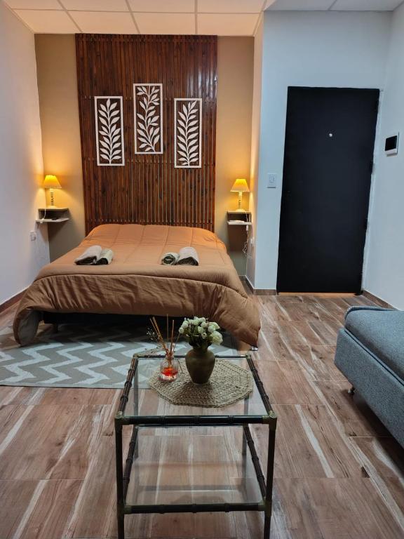 a bedroom with a bed and a table and a couch at Refugio Urbano 2 in Corrientes