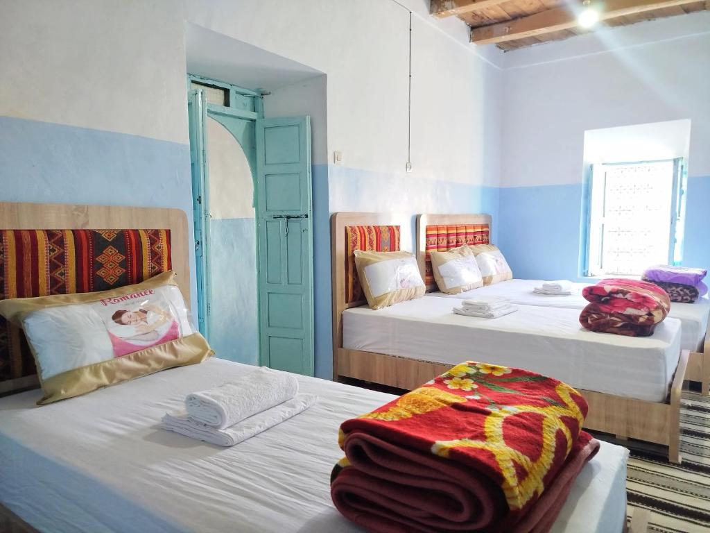 Postel nebo postele na pokoji v ubytování Tagmat guest house