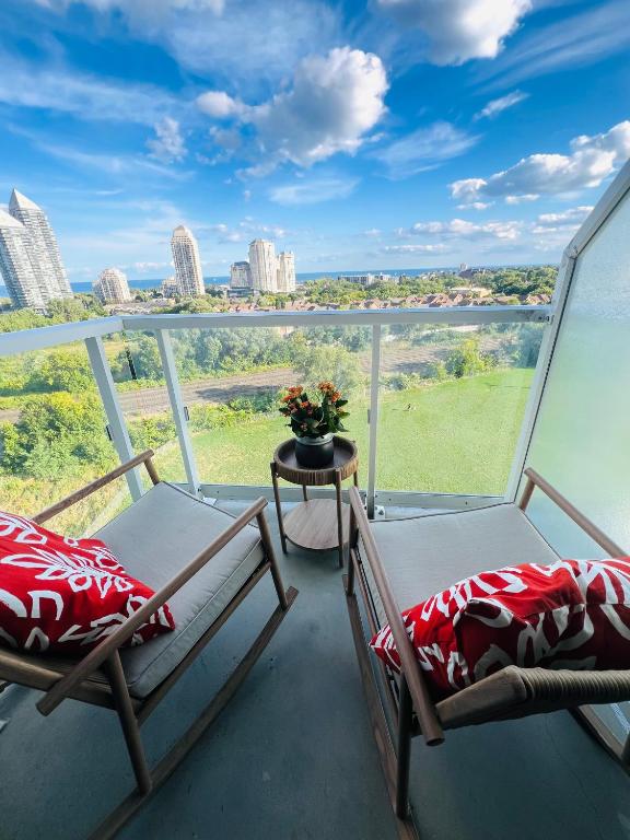 two chairs on a balcony with a view of the city at Lakeview Steps to the lake & just minutes to downtown in Toronto