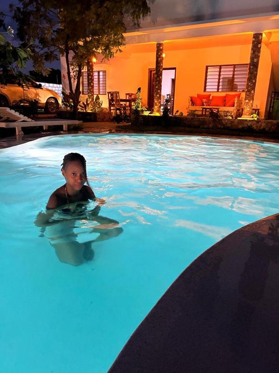 a young child in a swimming pool at Villa Verona Watamu in Watamu