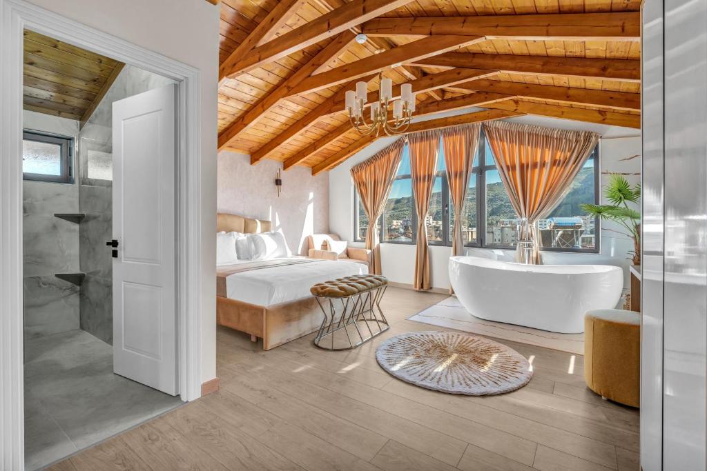 a bedroom with a bed and a tub in a room at Villa Soni in Berat