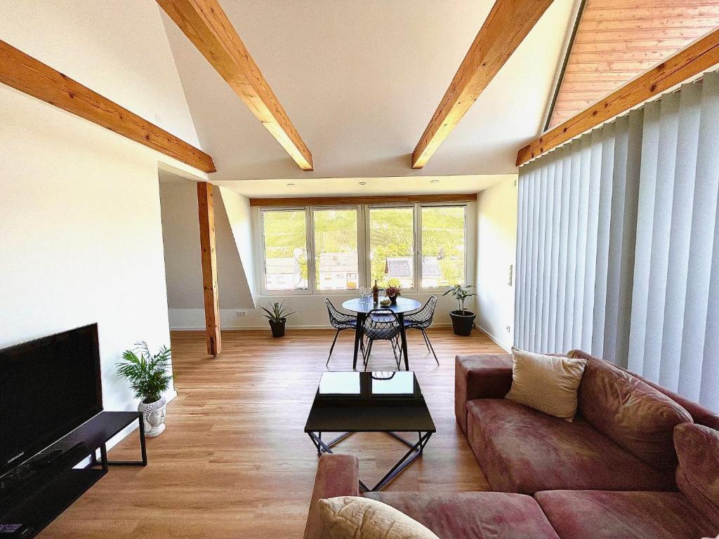 a living room with a couch and a table at Hard to leave in Piesport