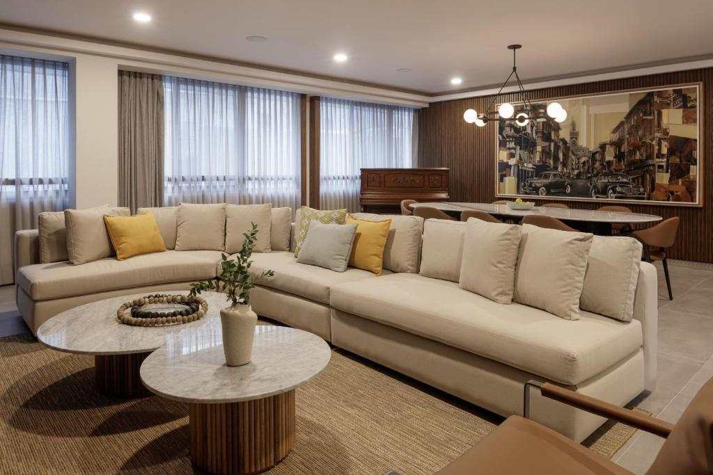 a living room with a couch and a table at Origen 438 Luxury Boutique Hotel in Guadalajara