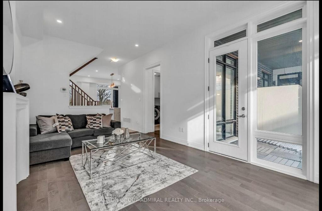 a living room with a couch and a glass table at Entire place in Richmond hill Modern Luxury Home in Richmond Hill