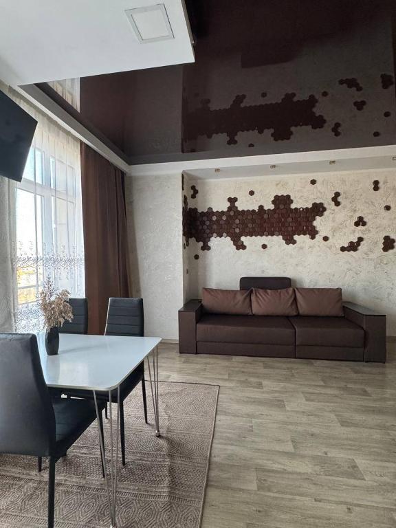 a living room with a couch and a table at Rivera Apartment Fontanka Sea in Fontanka