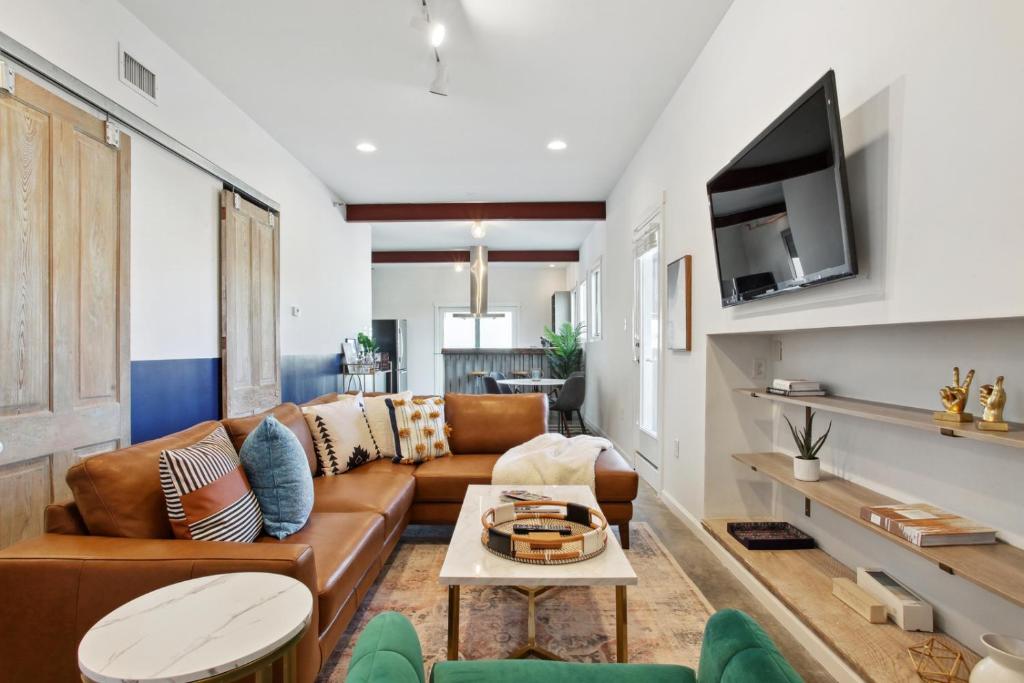 a living room with a couch and a table at Warehouse District Lovely One Bedroom and Den in New Orleans