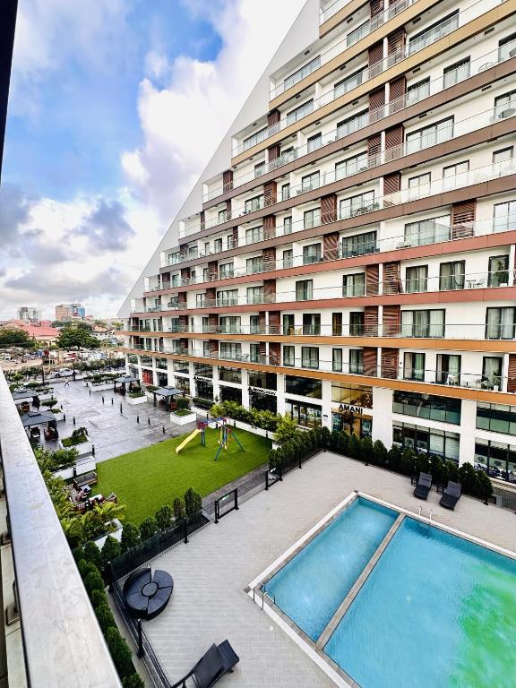 an overhead view of a large building with a swimming pool at RDA 1bedroom at The Signature Apartment in Accra