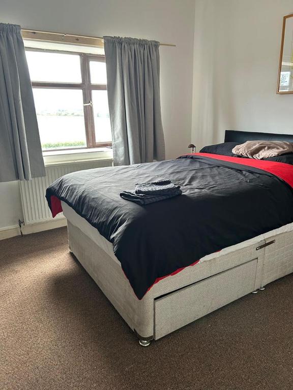 a bed sitting in a bedroom with a window at Crofton accommodation in Crofton
