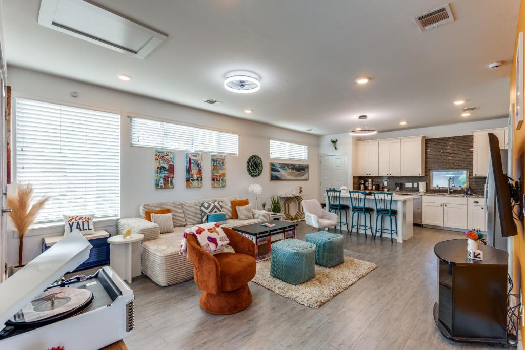 a living room with a couch and a table at The Q - Austin Family Home - Hot Tub & Golf Sim in Austin