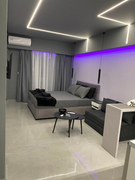 a living room with a couch and a table at Crystal Grey Elite Appartment 3 in Serres