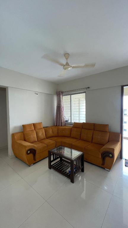 a living room with a couch and a coffee table at Silver Homes In Nagala Park Stay On 7th Floor in Kolhapur