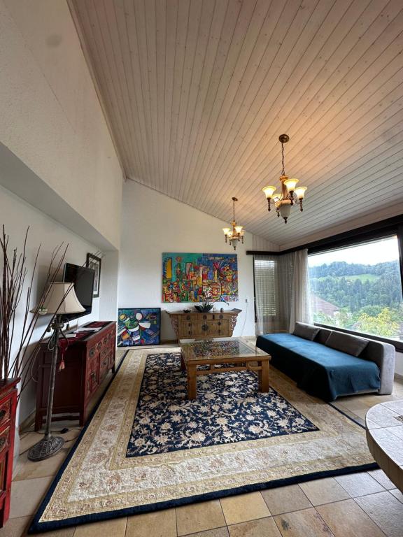 a living room with a couch and a table at Beautiful apartment near Luzern, view to Rigi,Pilatus Mountain in Luzern