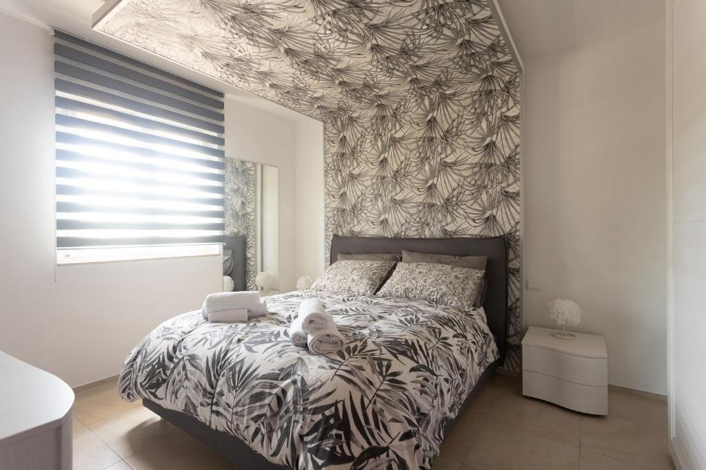 a dog laying on a bed in a bedroom at B&B Dream House in Campobasso