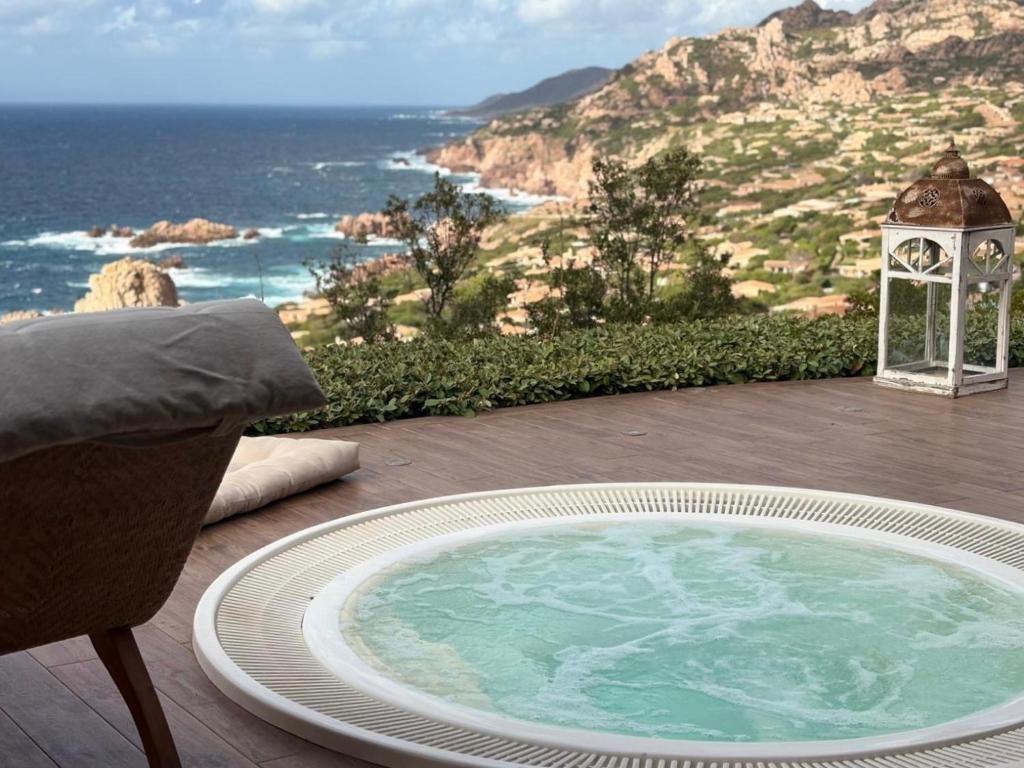 a hot tub on a patio with a view of the ocean at Villa La Dolce Vista & Private hydro pool in Costa Paradiso