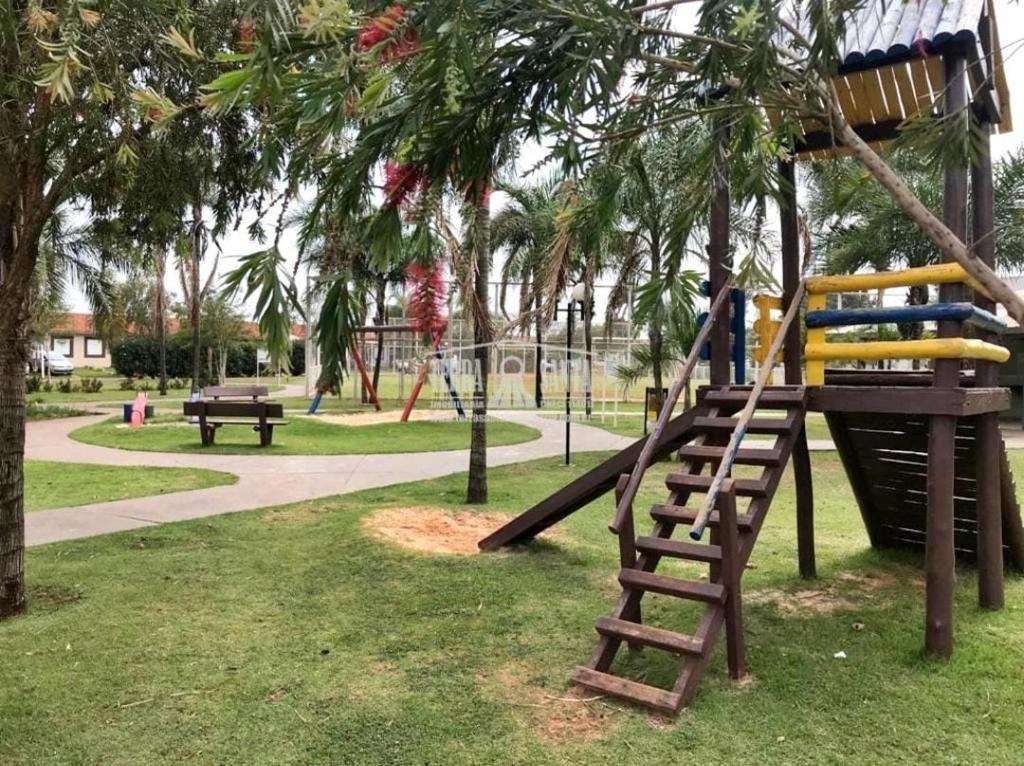 a playground with a slide in a park at Pedacinho do céu in Dourados