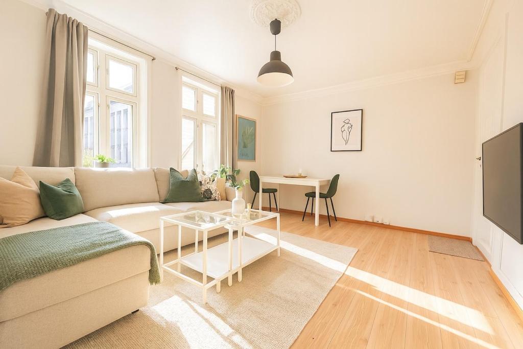 a living room with a couch and a table at Central & Quiet by Bryggen - Minimum Age 25 in Bergen