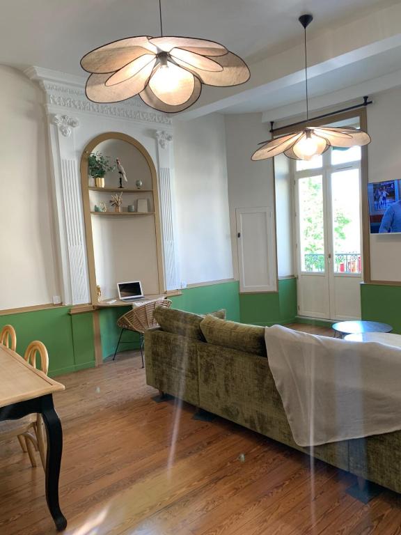 a living room with a couch and a table at OHANA Appartement de charme in Château-Gontier