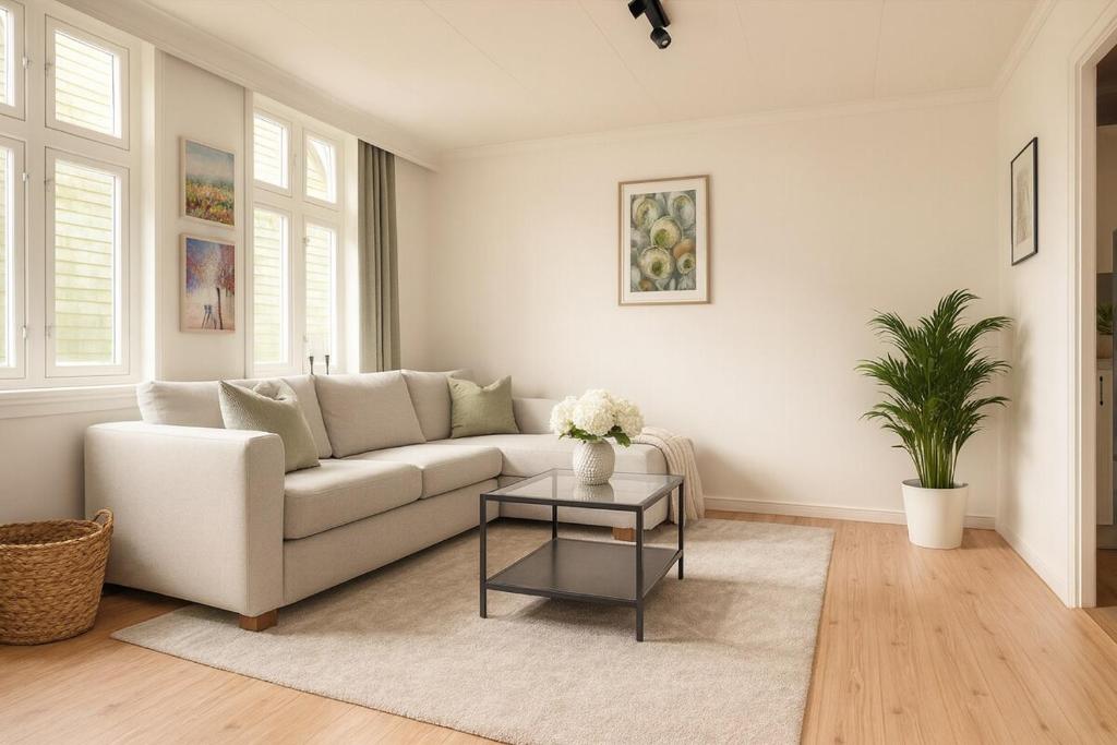 a living room with a white couch and a table at Delightful Bryggen Apartment - Minimum Age 25 in Bergen
