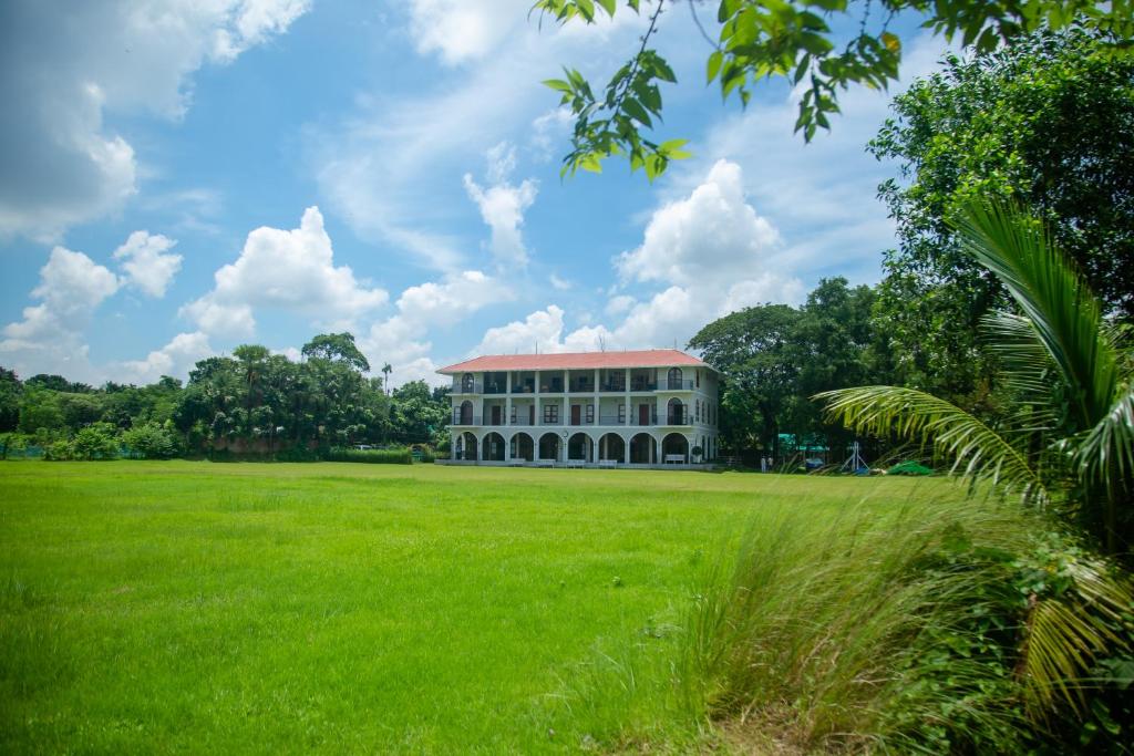a large building in a field of grass at The Pavilion at Riverside Park 
