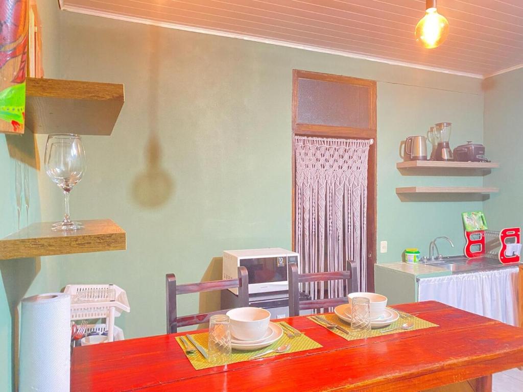 a kitchen with a table with cups and plates on it at Rous place# 2 in Fortuna