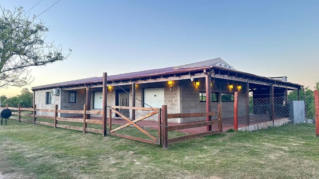 a house with a fence in front of it at ARROYO VEGA Casa 5ta in Esquina