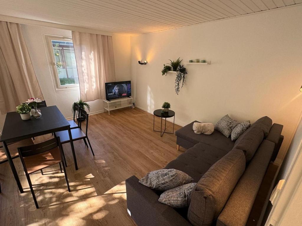 a living room with a couch and a table at Feriendorf Seddiner See - Bungalow 5 in Seddin