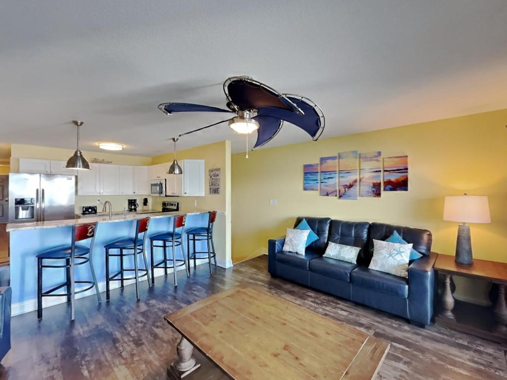 a living room with a couch and a kitchen at Put-in-Bay Waterfront Condo #105 in Put-in-Bay