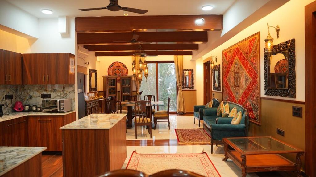 a kitchen and living room with a table and chairs at Penthouse Heritage in Hyderabad