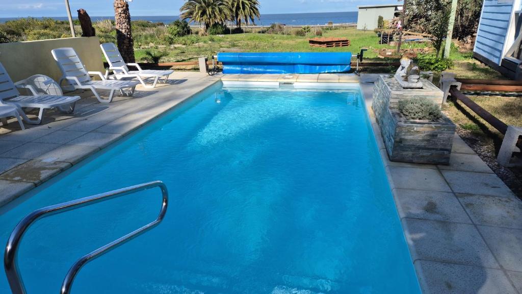 a swimming pool with blue water in a backyard at Cabañas San Jorge in Bella Vista