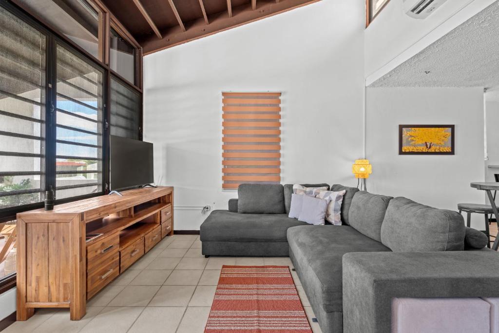 a living room with a couch and a flat screen tv at Terrace Allows Pets Free Parking Otium in Beltran