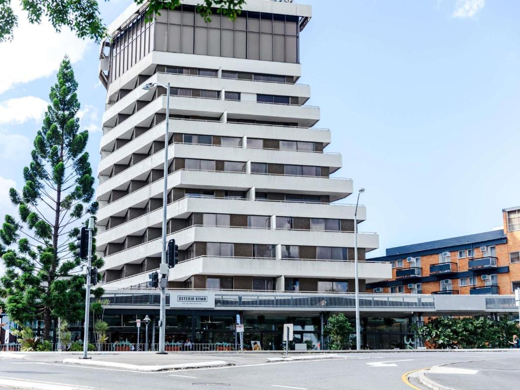 a tall apartment building with a street in front of it at Mercure Brisbane Spring Hill in Brisbane