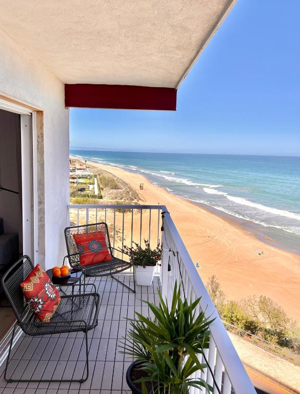 a balcony with a view of the beach at El Bikini Cullera - Junto a la playa - Right on the beach in Cullera