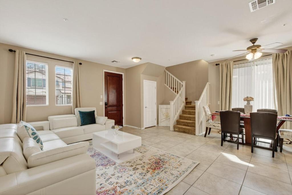 a living room with a white couch and a table at Entire Home Avondale 4Bedroom 3Bathroom in Avondale