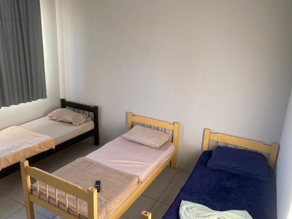 a room with two beds and a window at Mega Hotel in Cascavel