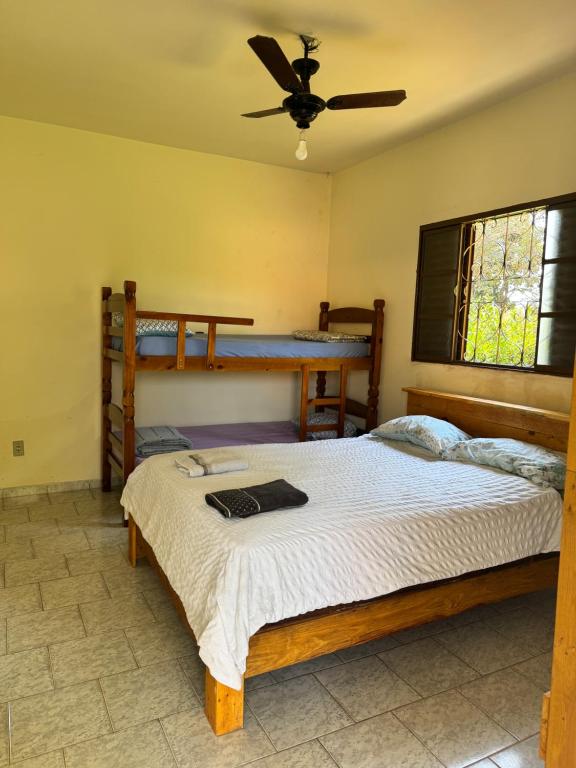 a bedroom with two bunk beds and a ceiling at Cute Rustic Cottage by the River in Caximba