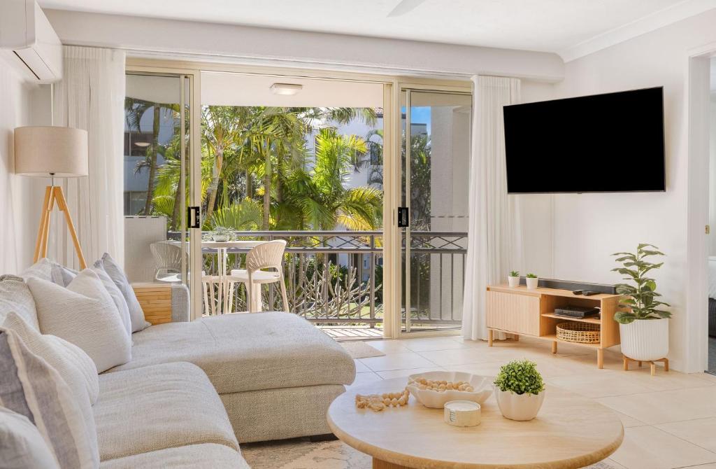 a living room with a couch and a tv at Tugun Bliss in Gold Coast