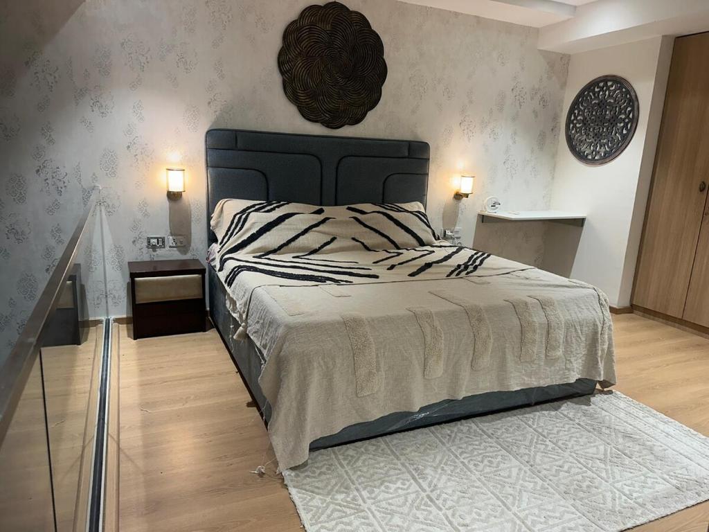 a bedroom with a large bed with a black headboard at Loft 74 Studio's in Gurgaon
