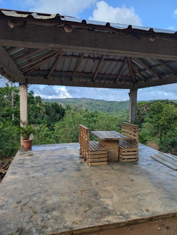 a pavilion with a table and a view of the mountains at El Conuco de Jose 
