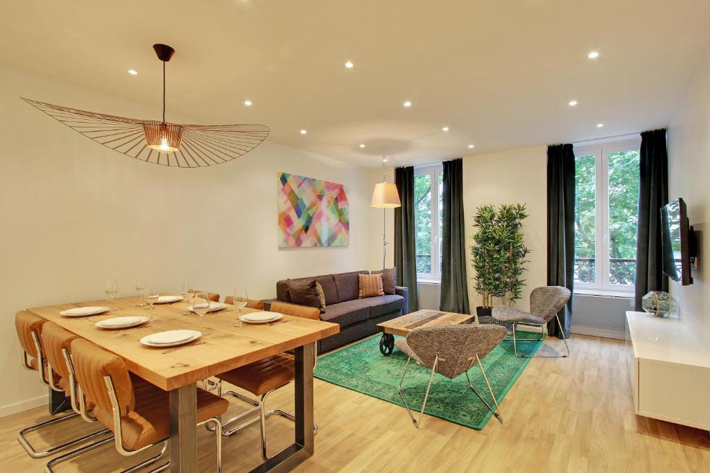 a dining room and living room with a table at Pick A Flat's in Champs Elysees - Rue Percier in Paris