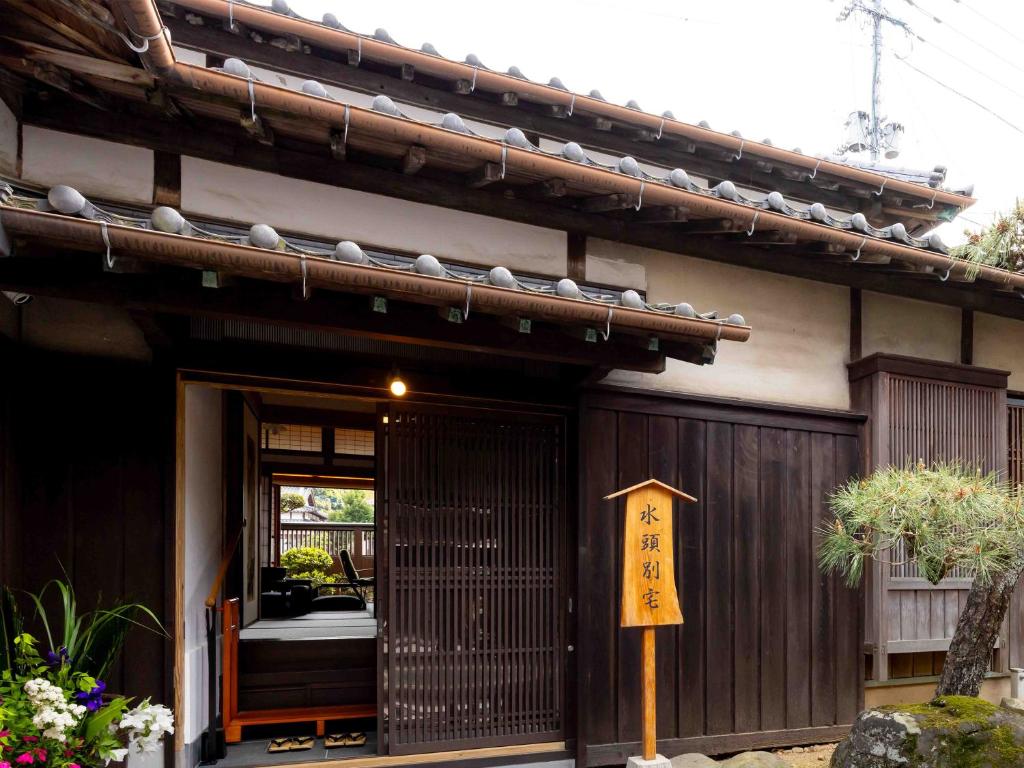 an asian house with a sign in front of it at 総襖絵の宿 水頭別宅 Suito Bettaku 19 years old minimum age to stay in Hama