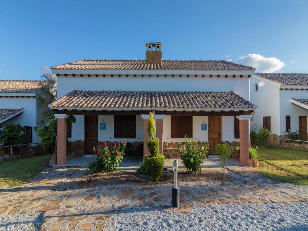 a large white house with a roof at Bungalow with Pool in Pozo Alcón in Cuenca