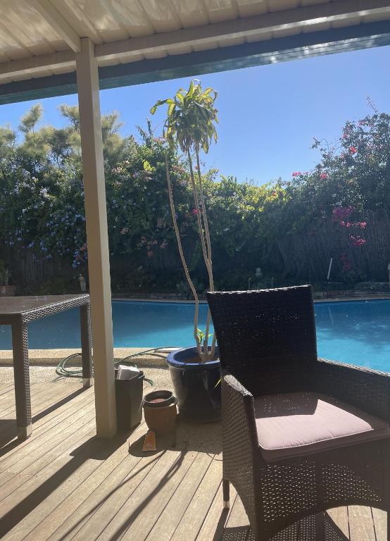 a patio with a table and a chair on a deck at a perfect weekend getaway in Rockingham