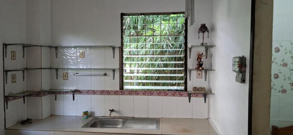 a bathroom with a sink and a window at Lowest Price Room In Chinatown Davao with WiFi Room 6 in Davao City