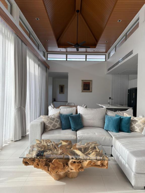 a living room with a couch and a table at Luxury Villa Phuket in Phuket