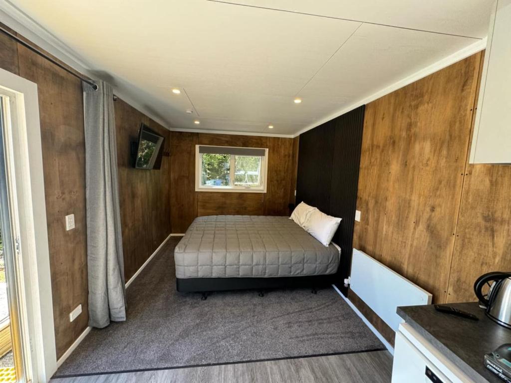 a small bedroom with a bed in a house at Evening Cove in Half-moon Bay